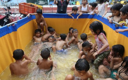 <p><strong>NOT A CARE.</strong> It doesn’t take much for children to enjoy an afternoon together, like this bunch in Barangay Pinyahan, Quezon City on May 9, 2023. Just dipping in a makeshift pool and everything is all right in their world. <em>(PNA photo by Joan Bondoc)</em></p>
