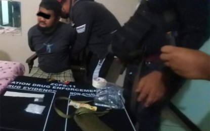 <p><strong>NABBED.</strong> Policemen arrest Momer Akari, 39, a member of the Barangay Intelligence Network in an anti-drug operation at a local motel in Barangay Canelar, Zamboanga City, on Tuesday (May 9, 2023). Seized from him were some PHP340,000 worth of shabu. <em>(Photo courtesy of Zamboanga City Police Office)</em></p>