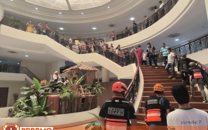 <p><strong>MILD QUAKE</strong>. Members of the Provincial Disaster Risk Reduction and Management Office assist Capitol employees and visitors as they evacuate a building during a mild earthquake on Friday morning (May 12, 2023). The magnitude 3.3 earthquake was tectonic in origin. <em>(Photo courtesy of PDRRMO Ilocos Sur)</em></p>