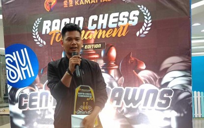 <p><strong>CHESS CHAMPION.</strong> International Master Michael Concio Jr. of Dasmariñas City speaks during the awarding ceremony of the 8th Kamatyas FIDE Rated Rapid Chess Invitational tournament at a mall in Las Piñas City on May 13, 2023. Concio scored 8.5 points to win the nine-round Swiss system competition. <em>(Contributed photo)</em></p>