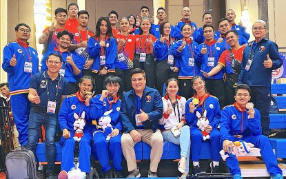 <p><strong>CHAMPION</strong>. Senate President Juan Miguel Zubri (seated third from left) poses with members of the national arnis team during the SEA Games in Phnom Penh, Cambodia on May 14, 2023. Zubiri, president of the Philippine Eskrima Kali Arnis Federation (PEKAF), lauded Filipino arnis team for winning six golds, two silvers and four bronzes. <em>(Contributed photo)</em></p>