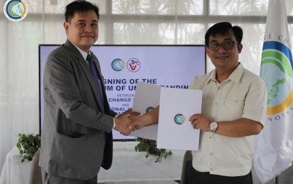 <p><strong>CLIMATE CHANGE.</strong> Climate Change Commission Vice Chairperson and Executive Director Robert Borje (left) and Philippine National Volunteer Service Coordinating Agency Executive Director Donald James Gawe shake hands after the signing of a memorandum of agreement in this undated photo. The MOA seeks to maximize volunteerism and community participation in combatting climate change in the country. <em>(Photo courtesy of the CCC)</em></p>