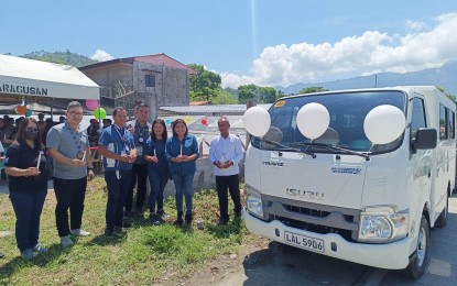 <p><strong>AID FOR TABLEA PRODUCTION.</strong> Officials of the Department of Agriculture - Philippine Rural Development Project (DA-PRDP), Maragusan Multipurpose Cooperative (MAMPCO), and the Davao de Oro provincial government attend the blessing of the air-conditioned delivery van donated to the MAMPCO on Wednesday (May 17, 2023). The van is part of the PHP7.5 million aid of DA-PRDP to the cooperative to improve their “tablea” production and earn more income<em>. (Photo courtesy of DA-PRDP)</em></p>