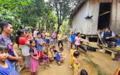 <p><strong>NO SCHOOL</strong>. Matuguinao, Samar Mayor Aran Boller (sitting on stairs) talks to children and parents of remote San Roque village. The community, the farthest from the town center, has no school. (<em>Photo from FB page of Aran Boller</em>)</p>