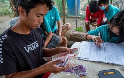 <p><strong>SKILLS TRAINING.</strong> One of the 500 out-of-school youth from the pilot cities of Cebu, Cagayan de Oro, Davao, Cotabato, and Quezon City counts his savings, in this undated photo. Through the Opportunity 2.0 project, the US Agency for International Development (USAID) boosted the financial management and entrepreneurial skills of the youngsters in these areas. <em>(Photo courtesy of U.S. Embassy)</em></p>