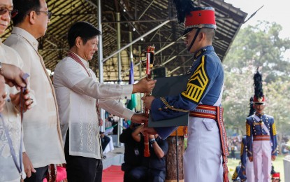 <p><strong>CUM LAUDE.</strong> President Ferdinand R. Marcos Jr. hands the Presidential Saber to Cadet First Class Warren Leonor, the valedictorian, during the Philippine Military Academy graduation rites at Fort Del Pilar, Baguio City on Sunday (May 21, 2023). The Lipa City, Batangas native topped the MADASIGON (MAndirigmang May DAngal SImbolo ng Galing at PagbangON or Warriors with Dignity Symbol of Excellence and Recovery) Class of 2023, composed of 238 males and 72 females. <em>(PNA photo by Rolando Mailo)</em></p>