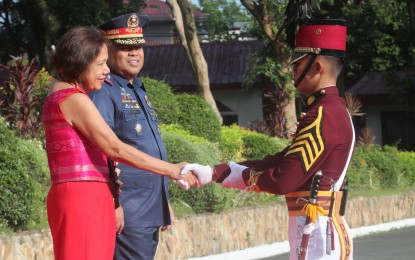<p><strong>GUEST OF HONOR.</strong> Senator Cynthia Villar shakes hands with a PNPA cadet during the arrival honors at the Philippine National Police Academy in Camp General Mariano Castañeda, Silang, Cavite on Monday (May 22, 2023). Also in photo is PNPA director Maj. Gen. Eric Noble. Villar said aside from contributing to food sustainability, these cadets can also actively contribute to disaster preparedness and recovery efforts, particularly in rural areas heavily reliant on farming. <em>(PNA photo by Avito Dalan) </em></p>