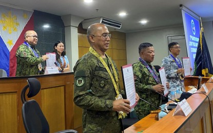 <p><strong>INSURGENCY-FREE.</strong> Officials of security agencies, including (1st row, from left) Brig. Gen. Orlando Edralin, commander of 303rd Infantry Brigade; Brig. Gen. Archival Macala, officer-in-charge of Police Regional Office-Western Visayas; and Commodore Arnaldo Lim, commander of  Coast Guard District-Western Visayas, show the signed resolution declaring Bacolod City as “insurgency-free” during Regional Joint Peace and Security Coordinating Center meeting held at the Bacolod City Government Center on May 19, 2023. The signing was witnessed by Lt. Gen. Patrick Villacorte, (2nd row, left) chief of Area Police Command Visayas; and Councilor Psyche Marie Sy. <em>(Photo courtesy of Councilor Pao Sy Facebook page)</em></p>