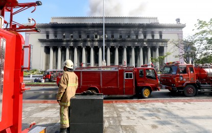 <p><strong>CHARRED.</strong> Smoke billows out of the Manila Central Post Office building in Liwasang Bonifacio on May 22, 2023. The Department of Tourism is allocating PHP15 million for the rehabilitation and restoration of the neoclassical building that sits along the banks of the Pasig River. <em>(PNA file photo by Yancy Lim)</em></p>