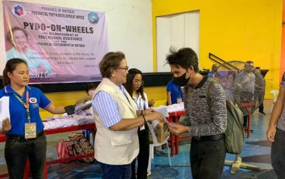<p><strong>EDUCATIONAL AID.</strong> Antique Governor Rhodora Cadiao distributes educational assistance to a student-beneficiary at the Binirayan gymnasium on May 17, 2023. Irish Manlapaz, who heads the Antique Provincial Youth Development Office, said in an interview Wednesday (May 24, 2023) that they are almost finished with the distribution of the assistance to students for the first semester of the school year 2022-2023. (<em>PNA photo courtesy of Antique PIO</em>)</p>