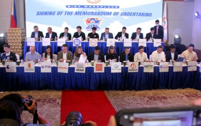<p><strong>DRUG-FREE WORKPLACES.</strong> Department of the Interior and Local Government Secretary Benjamin Abalos Jr. (center, top) signs a memorandum of understanding (MOU) with representatives from the country's top companies at the Eastwood Richmonde Hotel, Eastwood City, Quezon City on Thursday (May 25, 2023). The MOU provides for the promotion of drug-free workplaces in the private sector. <em>(PNA photo by Robert Oswald Alfiler)</em></p>