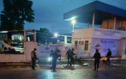 <p><strong>FOILED BOMBING.</strong> Army and police bomb experts deactivate two improvised bombs found at the main gate of Husky Bus Co. in Cotabato City early Thursday (May 25, 2023). The firm’s buses ply the Cotabato City-Gen. Santos City route. <em>(Photo courtesy of DXMS Radyo Bida)</em></p>