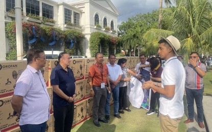 <p><strong>TURNOVER.</strong> Ilocos Norte Gov. Matthew Joseph Manotoc (with hat) leads the turnover of 3,086 electric fans to the three school divisions of the province, in front of the provincial capitol on Thursday afternoon (May 25, 2023). The provincial government allocated PHP5 million for this purpose. <em>(PNA photo by Leilanie Adriano)</em></p>