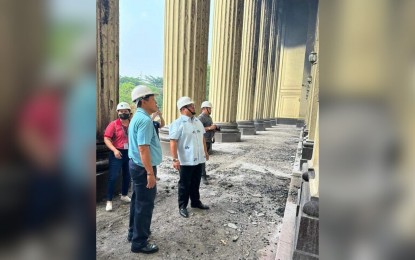 <p style="text-align: left;"><strong>DAMAGE ASSESSMENT</strong>. Government Service Insurance System (GSIS) President and General Manager Wick Veloso (in polo barong) and Postmaster General Luis Carlos (in sky blue shirt) inspect the damages sustained by the Manila Central Post Office Building on Thursday (May 25, 2023). The GSIS has started its assessment to determine the cost of damage to the building and its contents which are insured with that state pension fund. <em>(Photo courtesy of GSIS)</em></p>