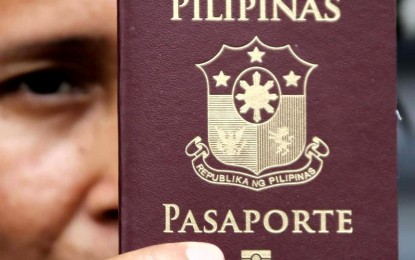 <p><strong>NOT ABSOLUTE.</strong> A woman claims her renewed passport at a mall in Quezon City on Friday (May 26, 2023). The law recognizes the constitutional right to travel unless it will impair national security, public safety or public health. <em>(PNA photo by Joan Bondoc)</em></p>