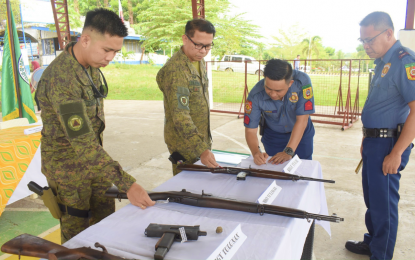 <p><strong>‘TOOLS OF VIOLENCE’.</strong> Police and military officials view the loose firearms that local officials collected from their constituents and turned over to the Army in Datu Anggal Midtimbang municipality in Maguindanao del Sur on Thursday (May 25, 2023). At least eight high-powered firearms coming from seven barangays of the town were surrendered to the authorities. <em>(Photo courtesy of Army’s 601st Infantry Brigade)</em></p>