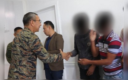 <p><strong>SURRENDER.</strong> Rear Admiral Donn Anthony Miraflor (left), Naval Forces Western Mindanao commander, welcomes the Abu Sayyaf Group members who have turned their backs on terrorism in Zamboanga City on Thursday (May 25, 2023). The surrenderers underwent medical checkups and debriefing and will be evaluated for inclusion in government assistance. <em>(Photo courtesy of NFWM-PIO)</em></p>