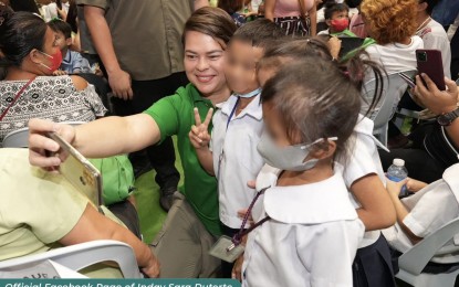 <p><strong>SOUVENIR.</strong> Vice President Sara Z. Duterte takes photos with learners at the launch of the "PagbaBAGo: A Million Learners and Trees" initiative at Mandaue City Sports Complex in Cebu province on Saturday (May 27, 2023). A total of 1,000 Grades 1 and 4 students received backpacks containing school supplies and dental kits while the city government was given seedlings for tree-planting activities.<em> (Courtesy of Inday Sara Duterte Facebook)</em></p>