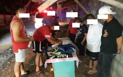 <p><strong>CAUGHT.</strong> Police agents process 3,800 grams of shabu worth PHP25.8 million and other evidence after a buy-bust in Caloocan City on Saturday night (May 27, 2023). Two suspects (right row, 3<sup>rd</sup> and 4<sup>th</sup> from left) were nabbed after selling the illegal substance to a poseur buyer. <em>(Courtesy of Caloocan City Police Station Facebook)</em></p>