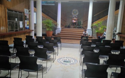 <p><strong>SILENCE</strong>. Security guards sit quietly in the lobby of the Negros Oriental Provincial Capitol where the wake of the late Gov. Carlo Jorge Joan Reyes will be held on Saturday (June 3, 2023). The remains of the former governor, who died on Wednesday (May 29, 2023) will be brought to his hometown, Guihulngan City, where he will be laid to rest. <em>(Photo courtesy of the Capitol PIO)</em></p>