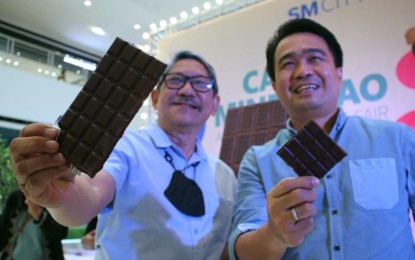 <p><strong>\MINDANAO CHOCOLATE.</strong> Abel James Monteagudo, director of the Department of Agriculture in Davao Region (DA-11) (left) and Davao City Councilor Bernard Al-ag show the chocolates made by Mindanaoan chocolatiers during the opening of the 2nd Cacao Mindanao Artisan Chocolate Fair at SM City Davao on Friday (June 2, 2023). On the same day, a chocolate trade fair is held in Zamboanga City participated by nine local and regional cacao growers.<em> (PNA photo by Robinson Niñal Jr.)</em></p>