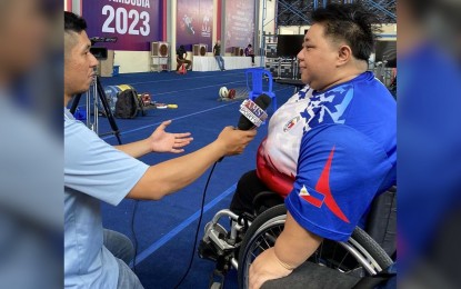 <p><strong>TOP BET.</strong> Veteran powerlifter and Sydney Paralympian Adeline Dumapong-Ancheta (right) grants an interview to a local reporter after the team's training session at the National Paralympic Committee of Cambodia Hall in Phnom Penh on Friday (June 2, 2023). Three veterans and two rookies will see action at the start of powerlifting competitions on Sunday (June 4). <em>(Contributed photo)</em></p>