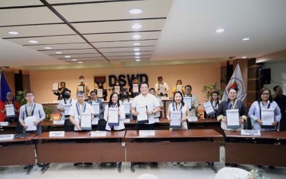 <p><strong>PARTNERS.</strong> Department of Social Welfare and Development Secretary Rex Gatchalian (front row, center) leads the signing of a formal agreement with 25 service providers at the DSWD central office in Quezon City on Saturday (June 3, 2023). The deal will ensure that DSWD-issued guarantee letters for beneficiaries of the Assistance to Individuals in Crisis Situations program will be recognized and accepted by hospitals, medical service providers and funeral homes. <em>(Courtesy of DSWD)</em></p>