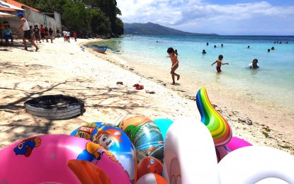 <p><strong>LAMBUG BEACH.</strong> Children play at the portion of Lambug Beach in Badian town, south of Cebu province, in this undated photo. Governor Gwendolyn Garcia on Tuesday (June 6, 2023) said the provincial government is taking over the operations of Lambug Beach and the Kawasan Falls in order to implement safety measures. <em>(PNA file photo by John Rey Saavedra)</em></p>