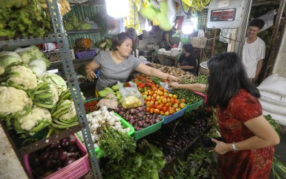 <p><strong>INFLATION.</strong> A vegetable vendor tends to a customer at the Paco Public Market in Manila on June 6, 2023. While headline inflation in June further slowed to 5.4 percent from May’s 6.1 percent, senators are looking forward to hearing President Ferdinand R. Marcos Jr.'s plans on how to further tame inflation during his second State of the Nation Address (SONA) on July 24.<em> (PNA photo by Yancy Lim)</em></p>