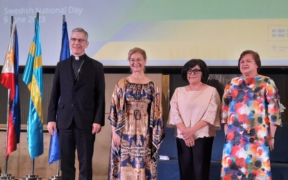 <p><strong>SWEDEN NAT'L DAY.</strong> Papal Nuncio to the Philippines Archbishop Charles John Brown, Ambassador Thunborg, Environment Secretary Yulo-Loyzaga, and Foreign Affairs Undersecretary Ma. Theresa Lazaro (left to right) pose for a photo during the Sweden National Day celebration in Taguig City on Tuesday (June 6, 2023). Sweden and the Philippines seek to strengthen their collaboration on environmental protection and explore ways to accelerate the latter’s green transition. <em>(PNA photo by Joyce Rocamora)</em></p>