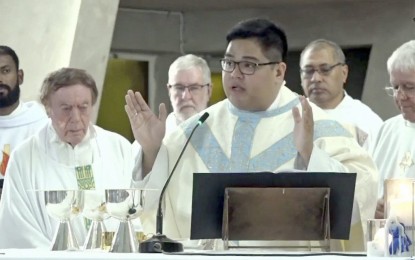 <p>Newly ordained Fr. Andric Dean Taberdo during the ordination ceremony. <em>(Screenshot from Diocese of Darwin video)</em></p>