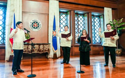 <p><strong>OATHTAKING.</strong> President Ferdinand R. Marcos Jr. administers the oath of office to three newly appointed officials in a ceremony held at Malacañan Palace in Manila on Wednesday (June 7, 2023). Suharto Mangudadatu took oath as director general of the Technical Education and Skills Development Authority, Katrina Ponce Enrile as administrator and chief executive officer of the Cagayan Special Economic Zone and Mohammed Hussein Pangandaman as administrator of the Authority of the Freeport Area of Bataan. <em>(Photo courtesy of Presidential Communications Office)</em></p>