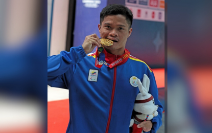 <p><strong>UK-BOUND SWIMMER.</strong> Paralympian Ernie Gawilan bites the gold medal he won in the men's 400m freestyle S7 at the 12th Asean Para Games in Phnom Penh, Cambodia on June 4, 2023. Gawilan and quadruple-gold winner Angel Mae Otom qualified to compete in the World Championships scheduled from July 31 to Aug. 6 in Manchester, United Kingdom. <em>(Media pool photo)</em></p>