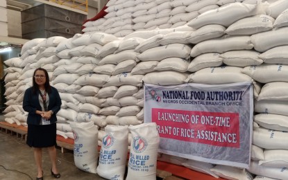 <p><strong>RICE STOCKS</strong>. Glenda Paz, acting branch manager of NFA in Negros Occidental province, shows to reporters the rice stocks being released under the one-time rice assistance for qualified employees and workers of national government agencies at the warehouse in Bacolod City on Thursday (June 8, 2023). In Negros Occidental, 73 percent or 5,800 bags of rice assistance have already been released to the beneficiaries who received 25 kilograms each.<em> (PNA photo by Nanette L. Guadalquiver)</em></p>