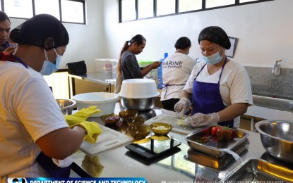 <p><strong>PROCESSED MUSSELS.</strong> Women work in a processing area designed for tahong-based products in Jiabong, Samar. With PHP500,000 worth of assistance from the Department of Science and Technology (DOST), members of the Maligaya Agri-Business Association (MABA) are now capable of producing up to 200 to 400 bottles of processed tahong monthly from just 20 bottles before the intervention. <em>(Photo courtesy of DOST)</em></p>