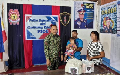 <p><strong>REBEL COUPLE YIELDS.</strong> New People’s Army couple “Jhon-Jhon” (holding child) and “Fiona” surrender to Surigao del Sur Police Provincial Office on Thursday (June 8, 2023) after a month of negotiation. The couple belonged to the Sandatahang Yunit Pampropaganda Platoon 16C2, NPA Guerrilla Front 16, Sub-Regional Committee Northland, North Eastern Mindanao Regional Committee <em>(Photo courtesy of PRO-13)</em></p>