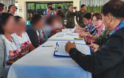 <p><strong>PEACE PACT.</strong> Former rebels and government officials sign a memorandum of agreement to completely eradicate insurgency in Samar province in this June 5, 2023 photo. Among the roles of the peacebuilders are ensuring that rebels will no longer be able to recruit new members, encourage active NPA members to surrender, and support government programs on ending insurgency. <em>(Photo courtesy of Samar provincial government)</em></p>