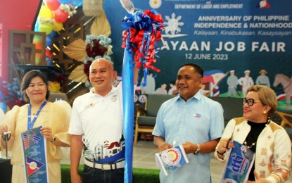 <p><strong>INDEPENDENCE DAY.</strong> Department of Labor and Employment Caraga Region (DOLE-13) Regional Director Joffrey Suyao (2nd left) opens the 125th Araw ng Kalayaan Job Fair at the SM mall in Butuan City on Monday (June 12, 2023). The agency released on the same day PHP15.6 million in payments for 3,948 beneficiaries of the TUPAD program and PHP8 million to 382 beneficiaries of the agency's livelihood program. <em>(Photo courtesy of DOLE-13)</em></p>