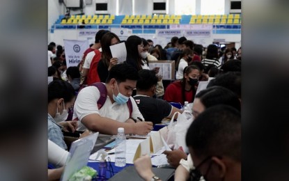 <p><strong>JOB APPLICANTS</strong>. Job seekers fill out application forms at a job fair held at Bulacan Capitol Gym, Malolos City, Bulacan on Monday (June 12, 2023). In line with the Independence Day celebration, six job fairs were conducted in six sites in Central Luzon where some 12,000 vacancies were made available. <em>(Photo courtesy of DOLE - Central Luzon)</em></p>