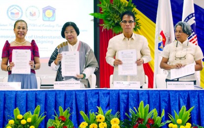 <p><strong>HOUSING FOR OFWs</strong>. A memorandum of understanding was signed between the Department of Migrant Workers, the Department of Human Settlements and Urban Development (DHSUD), and Pag-IBIG Fund on Tuesday (June 13, 2023). The MOU will assure that OFWs will be given slots in the government's housing program nationwide. <em>(PNA photo by Ben Briones) </em></p>