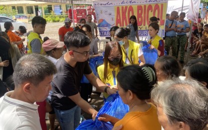 <p><strong>AID FOR EVACUEES</strong>. Ako Bicol (AKB) Rep. Raul Angelo Bongalon (2nd from left) distributes on Friday (June 16, 2023) family food packs, "malong", soap and bread to families sheltered at San Jose Elementary School in Malilipot town. AKB will install water system facilities in different evacuation centers in Albay province to ensure the supply of clean water for Mayon-affected evacuees. <em>(PNA photo by Connie Calipay)</em></p>