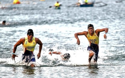 <p><strong>JAPAN-BOUND.</strong> Triathletes Iñaki Emil Lorbes (left) and Andrew Kim Remolino compete in Subic, Zambales in this photo taken two years ago. They will join the Asia Triathlon U-23 and Junior Championships to be held in Gamogori City, Japan on June 22-26, 2023. <em>(Contributed photo)</em></p>