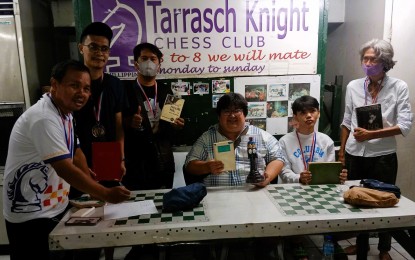 <p><strong>CHAMPION.</strong> National Master Almario Marlon Bernardino (4th from left) wins the Fide Master Anton Paolo Del Mundo Blitz Chess Open at Tarrasch Knight Chess Club inside the Guadalupe Commercial Complex in Makati City on Saturday (June 17, 2023). Also in photo are (from left) NM Nicomedes Alisangco (6th place), Errenz Dennison Calitisin (5th place), Rommel Lucion (3rd place), Christian Mendoza (2nd place), and Joel Cocjin (4th place). <em>(Contributed photo)</em></p>