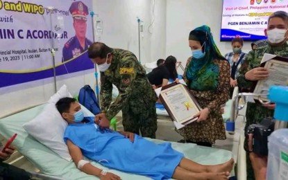 <p><strong>HEROES ALL.</strong> Philippine National Police chief, Gen. Benjamin Acorda Jr., pins a wounded personnel medal to one of the police officers injured in an ambush in Maguindanao del Sur province during his visit to the Sultan Kudarat provincial hospital on Monday (June 19, 2023). Acorda assures the sacrifices of the police officers will not be forgotten. <em>(Photo courtesy of PNP)</em></p>