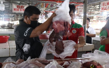 <p><strong>HOT MEAT.</strong> Meat inspectors from the Tarlac City Veterinary Office confiscate "hot meat" weighing some 40 kilos at the RUA Market on Tuesday (June 20, 2023). The operation was part of the city government's intensified crackdown against the proliferation of “double dead” meat products that did not pass the government’s inspection standards. <em>(Photo courtesy of the City Government of Tarlac)</em></p>