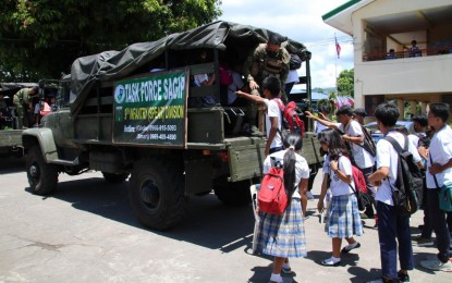 <p><strong>SCHOOL-BOUND</strong>. Students in Guinobatan, Albay go to their schools on Wednesday (June 21, 2023) despite being sheltered in different evacuation centers. The Philippine Army (PA) through the 9th Infantry Division started to provide shuttle rides for the learners affected by Mayon Volcano's effusive eruption. <em>(Photo courtesy of 9ID Task Force Sagip)</em></p>