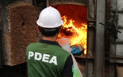 <p><strong>ILLEGAL DRUGS DESTROYED.</strong> A personnel of the Philippine Drug Enforcement Agency (PDEA) burns the illegal drugs seized in Regions 11, 12 and 13 on Thursday (June 22, 2023) at the Philippine-Japan Active Carbon Plant in Davao City. With an estimated PHP24.8 in street value, the illegal drugs include 2.5 kilos of shabu, 20.2 kilos of marijuana, and 779.95 grams of cocaine.<em> (PNA photo by Robinson Niñal Jr.)</em></p>