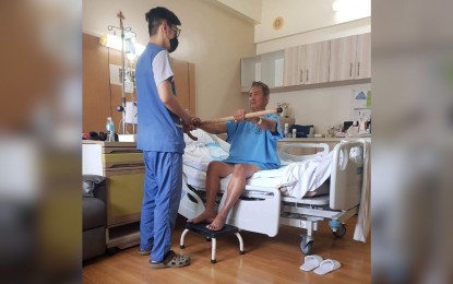 <p><strong>CARE FOR PATIENTS.</strong> A nurse assists a stroke patient confined at the Medical Center Manila in Manila City in exercising his arms in this undated photo. The PCO on Wednesday (Aug. 9, 2023) said President Ferdinand R. Marcos Jr. is open to the idea of forging an agreement with the US to elevate the nursing profession and address the problems besetting the sector. <em>(PNA photo by Ma. Teresa P. Montemayor)</em></p>