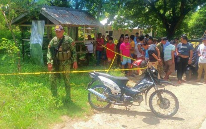 <p><strong>ROAD AMBUSH</strong>. A police officer conducts an ocular inspection on the site where a motorist was shot dead on Sunday (June 25, 2023) in Talayan, Maguindanao. The victim was killed on the spot while his back rider survived unharmed. <em>(Photo courtesy of Talayan MPS)</em></p>