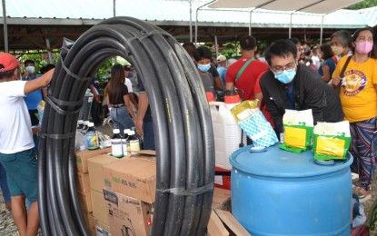 <p><strong>AGRI BOOST</strong>. Farmers receive farm input and equipment during a distribution at the Ilocos Norte Agriculture and Fisheries Extension System Building in Laoag, Ilocos Norte in this undated photo. To address the specific needs of farmers and fishers, the Ilocos Norte government opened an agri hotline to gather all agriculture-related requests. <em>(Contributed)</em></p>